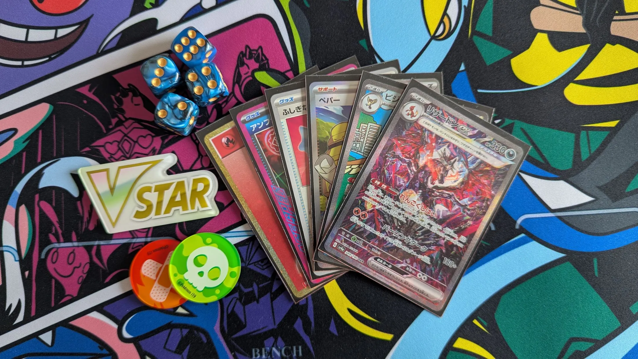 5 Pokemon Cards, some dice, a VSTAR market on top of a playmat.